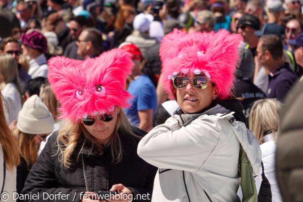Zwei Fans mit pinken Pelzhüten in der Crowd beim Top of the Mountain Closing Concert 2026 in Ischgl