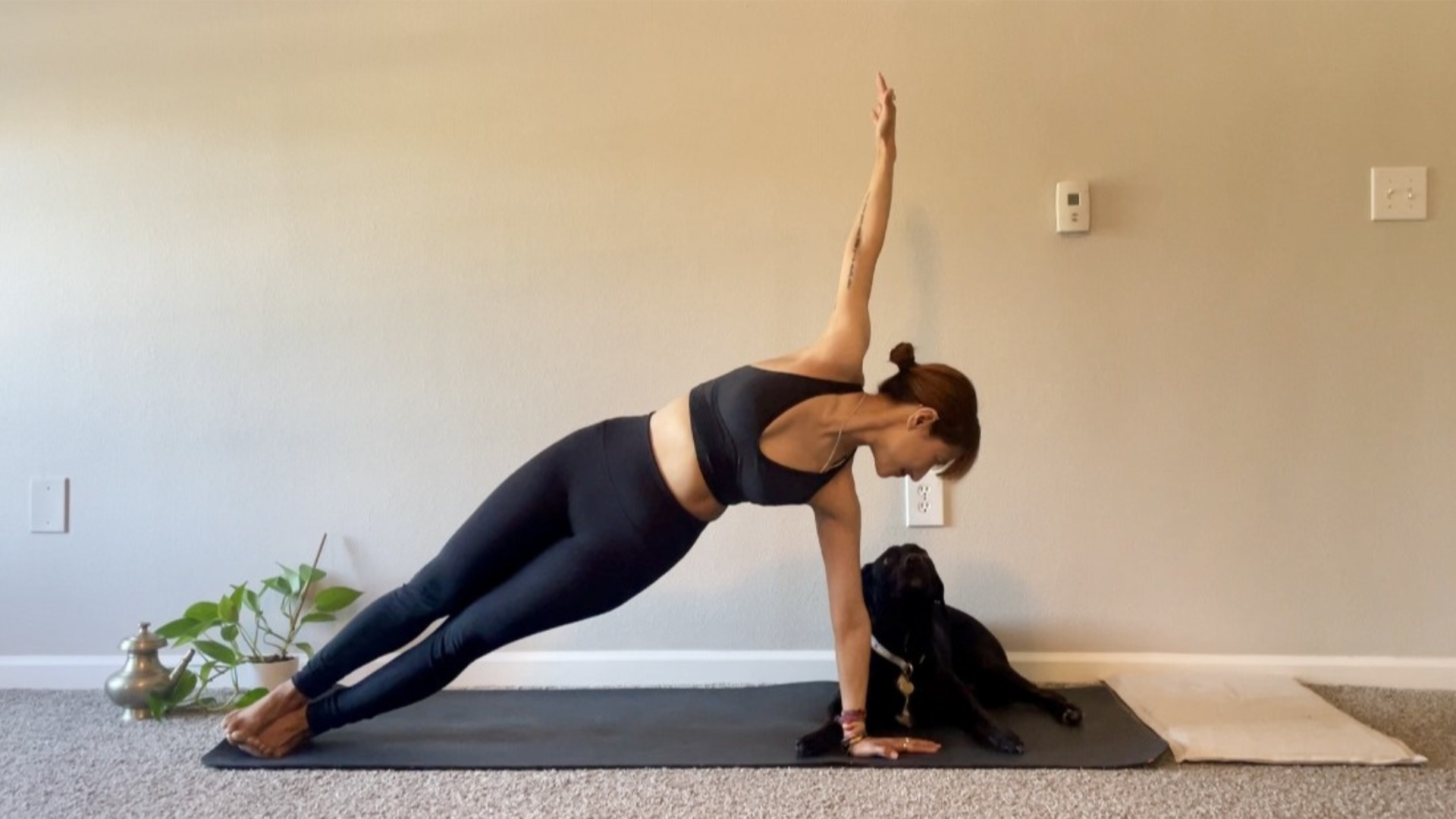 Woman in Side Plank on a yoga mat