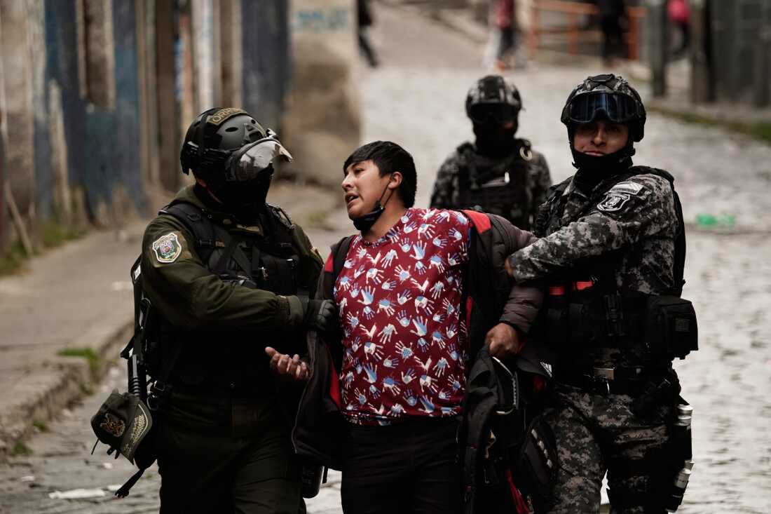 Police officers detain a demonstrator during an anti-government protest in La Paz, Bolivia, Monday, May 18, 2026.