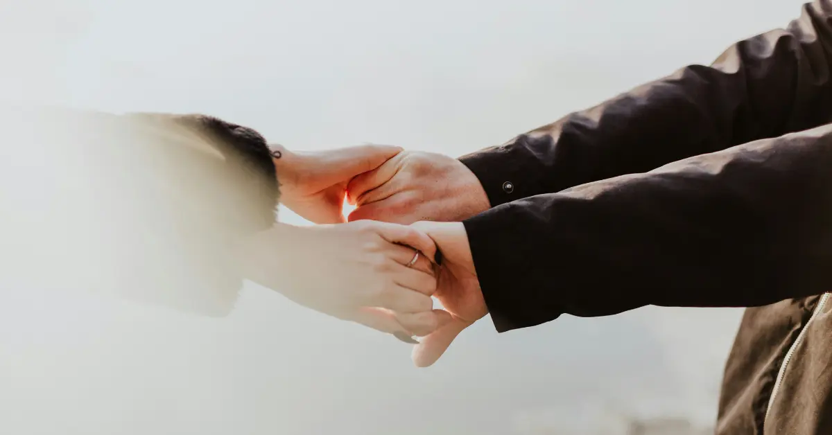 A couple holds hands