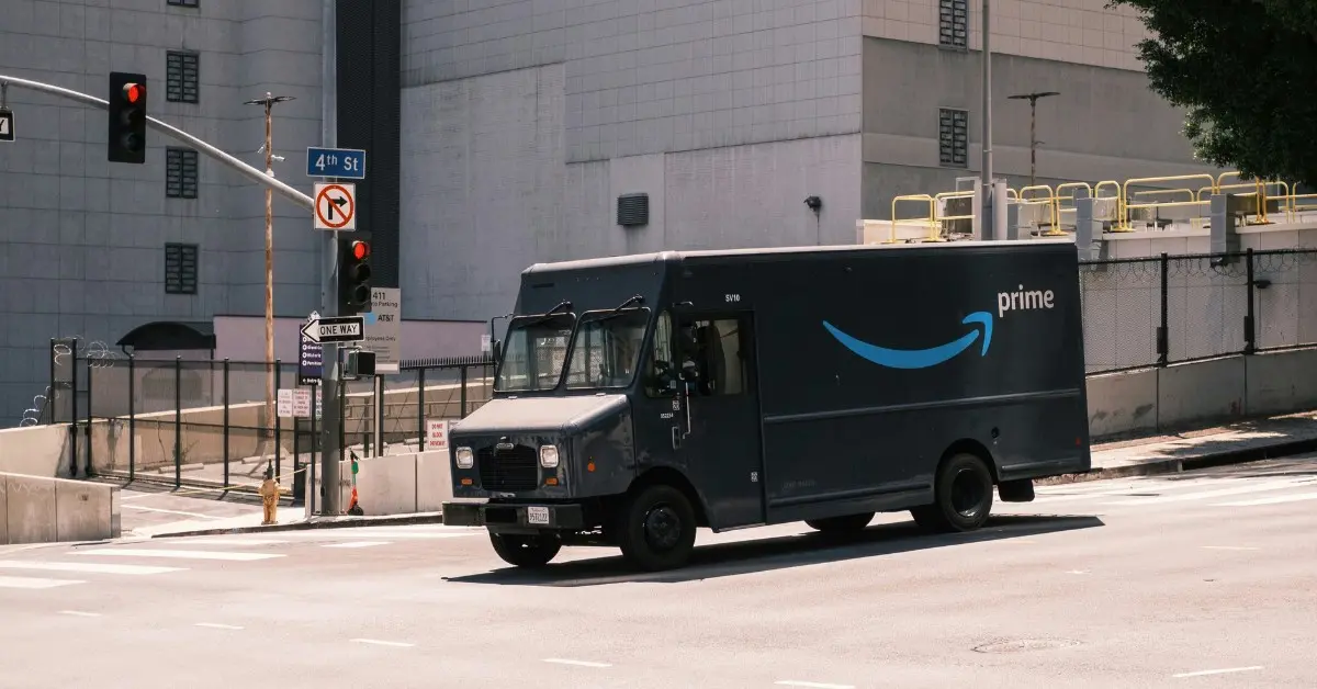 An Amazon truck drives down a city street