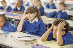 when praise backfires - demotivated, reluctant students sit in class at desk