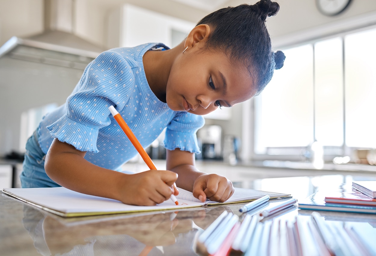 50+ Easy Travel Journal Ideas and Writing Prompts for Kids 6 Child adding color to her journal through drawing prompts and journal topics and ideas.