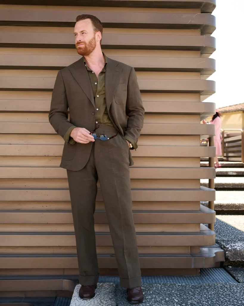 green unlined suit with matching linen shirt and brown leather loafers