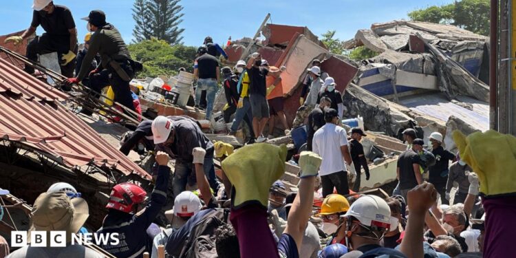 Anguish of Colombian brother at rubble of building being searched for earthquake survivors